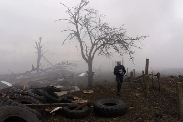 1 Photographer Evgeniy Maloletka picks his way through the aftermath of a Russian attack in Mariupol Ukraine Feb. 24 2022. From 20 DAYS IN MARIUPOL. Photo Credit AP Photo Mstyslav Chernov